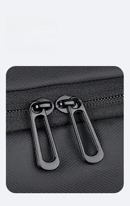 Detail of durable dual black metal zippers on high-density black oxford fabric backpack