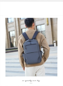 Close-up of a large-capacity dark gray business commute backpack with side drawstring pocket