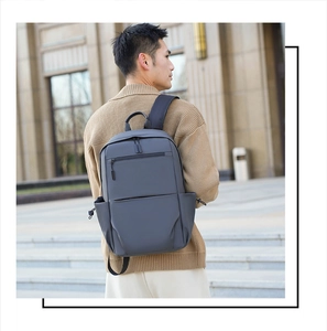 Detail of dark grey water-resistant fabric and side pocket on large business backpack