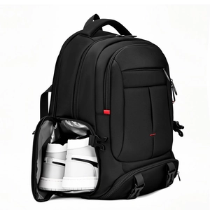 Detail of a large black backpack showing a separate breathable side shoe compartment