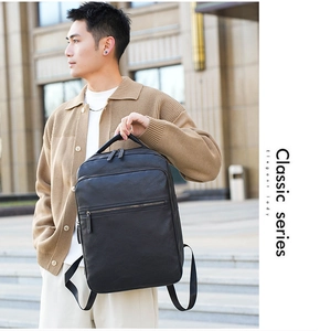 Close-up of black PU leather backpack with multiple zip pockets in outdoor city setting