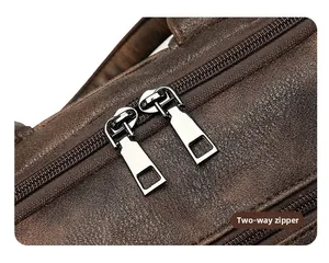 Detailed macro shot of durable metal dual zippers on a dark brown leather backpack