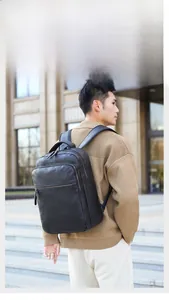Side view of black PU leather business laptop backpack with multiple zipper pockets