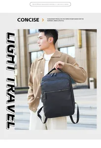 Outdoor view of a black PU leather men's backpack showing urban commuter style and texture