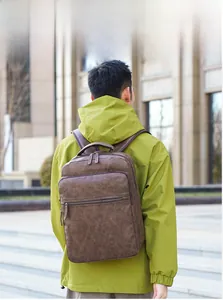 Man wearing a dark brown vintage leather backpack with multiple zipper pockets in outdoors