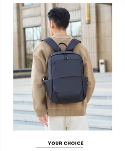 Outdoor view of minimalist black waterproof backpack with multiple pockets on male model