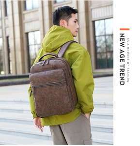 Side view of man in green jacket wearing vintage brown PU leather commuter backpack
