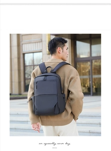 Close-up of matte black waterproof business backpack worn by model in city setting