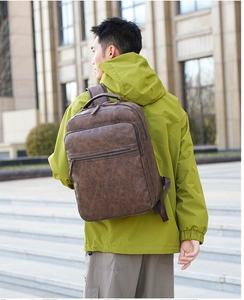 Deep brown PU leather backpack shown on model highlighting the vintage casual style and size