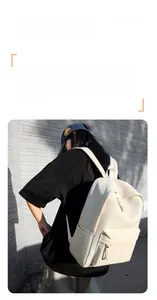 Detail of off-white minimalist backpack showing durable waterproof fabric and zipper pocket