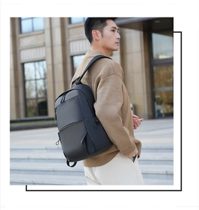 Business laptop backpack in black water-resistant fabric worn by a male model on street