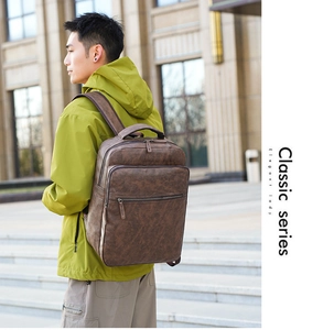 Deep brown vintage leather backpack worn by man during urban business commute