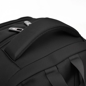 Macro shot of reinforced non-slip handle and durable oxford fabric on the black backpack