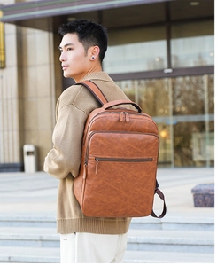 Brown PU leather backpack for men showing side profile and large capacity during commute