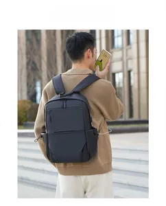 Close-up of waterproof black backpack showing USB charging port and side drawstring pockets