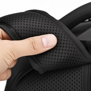 Macro detail of the breathable honeycomb mesh padding on black backpack shoulder strap