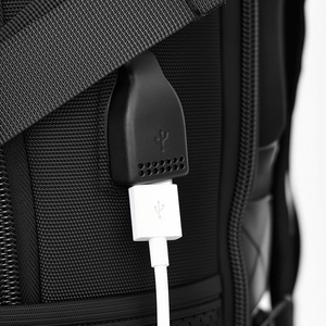 Detail of external USB charging port on high-density nylon travel backpack for men