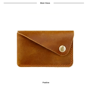 Macro detail of brown vintage leather card wallet with handmade stitching and gold metal buckle