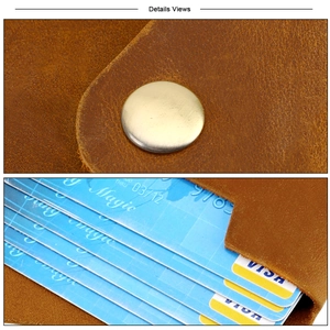 Macro view of vintage brown leather card holder with button closure and multi-slot interior