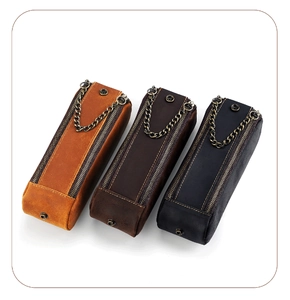 Three retro crazy horse leather pen pouches with dual zippers and metal chain accents