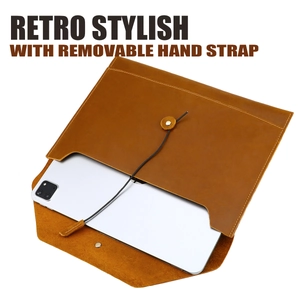 Detail of vintage brown leather laptop sleeve with twine closure and removable strap
