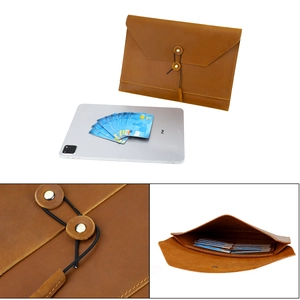 Detail of genuine leather laptop sleeve showing interior card slots and string closure
