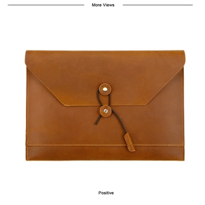 Detailed view of the brown leather envelope briefcase featuring a vintage string-tie closure