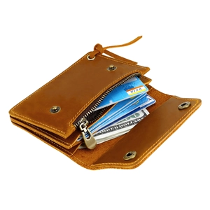 Macro shot of brown leather wallet interior showing multiple card slots and zipper pocket