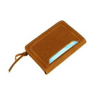 Detail view of brown crazy horse leather card holder with stitched slot and zipper pull