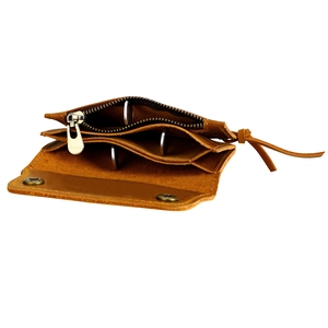 Detail of vintage brown leather coin purse showing three internal compartments and zipper