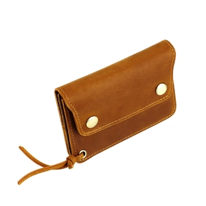 Macro view of vintage crazy horse leather wallet showing metal snaps and fine stitching