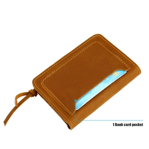 Detail of vintage brown leather wallet showing stitching and external bank card pocket