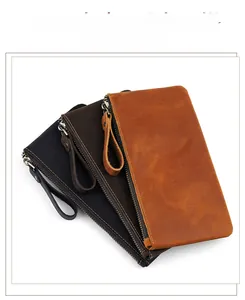 Detail of first-layer cowhide leather clutches with secure wrist straps and zippers