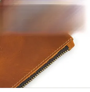Close-up of precise stitching and durable metal zipper on vintage crazy horse leather bag
