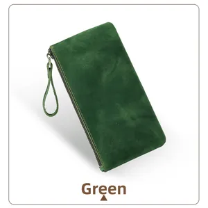 Close-up of green crazy horse leather clutch with bronze zipper and wrist strap