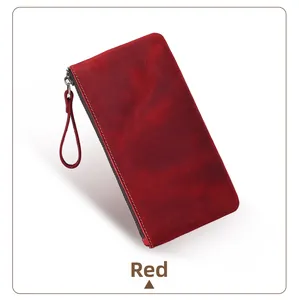 Detail of red crazy horse leather wallet featuring fine stitching and a metal zipper
