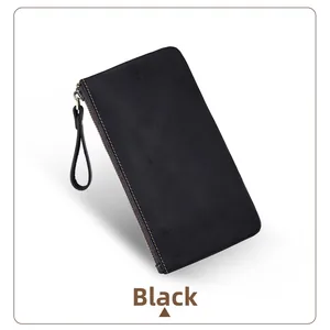 Macro detail of black crazy horse leather wallet featuring contrast orange stitching