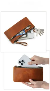 Macro view of vintage crazy horse leather pouch showing double zippers and large capacity
