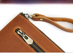 Macro detail of high-quality brown vintage leather wallet with smooth metal zipper pull