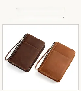 Close-up of premium leather travel wallet with wrist strap and precise stitching details