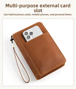 Brown leather travel organizer showing a side view slot for large smartphones