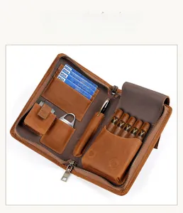 Interior detail of a brown leather travel cigar case with slots for cigars, cards and pens