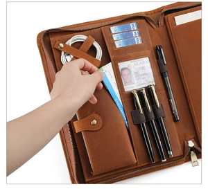 Macro detail of brown leather tablet folio with card slots and cable organizer