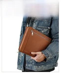Close-up of vintage brown leather iPad sleeve with zipper and distressed matte texture