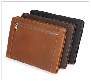 Detailed view of leather iPad sleeves in brown and black with vintage textured stitching