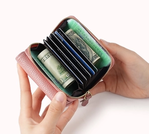 Pink lychee grain leather accordion card holder wallet with multiple slots in hand