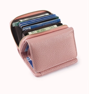 Detail of pink pebbled leather accordion wallet showing multiple card slots and metal zipper