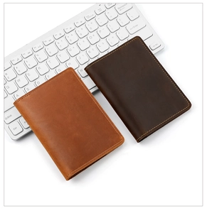 Close-up of vintage crazy horse leather passport covers showing fine stitching and texture