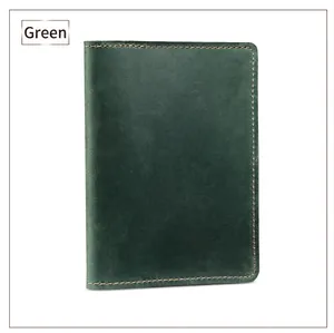 Detail of dark green crazy horse leather passport holder with yellow stitching