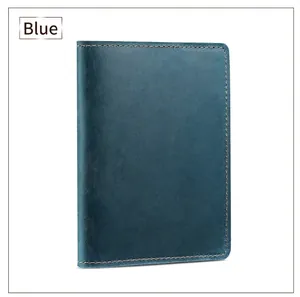 Detail of blue crazy horse leather passport holder with brown stitching and texture